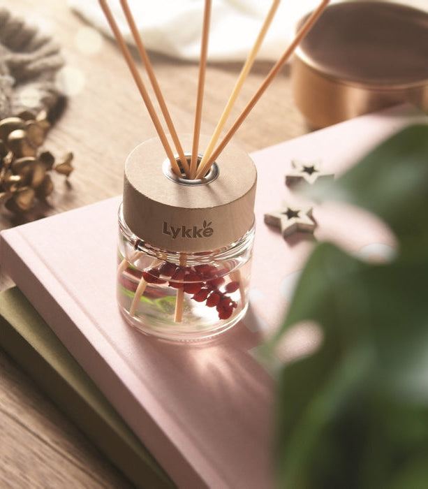 Diffuser with reeds on a surface with a blurred background