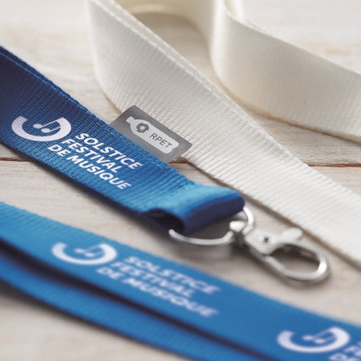Blue lanyard with text on a wooden surface