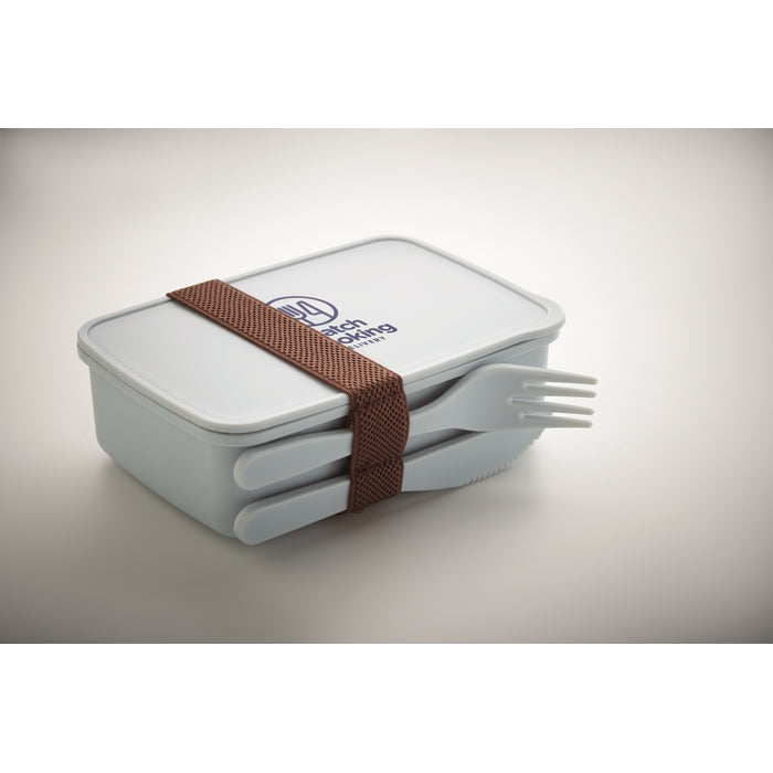 A square white plastic lunch box with a matching lid, secured with a brown woven strap, and shown with a white plastic fork resting out of the box. The lid has a blue logo that reads 'The Eating Place'.