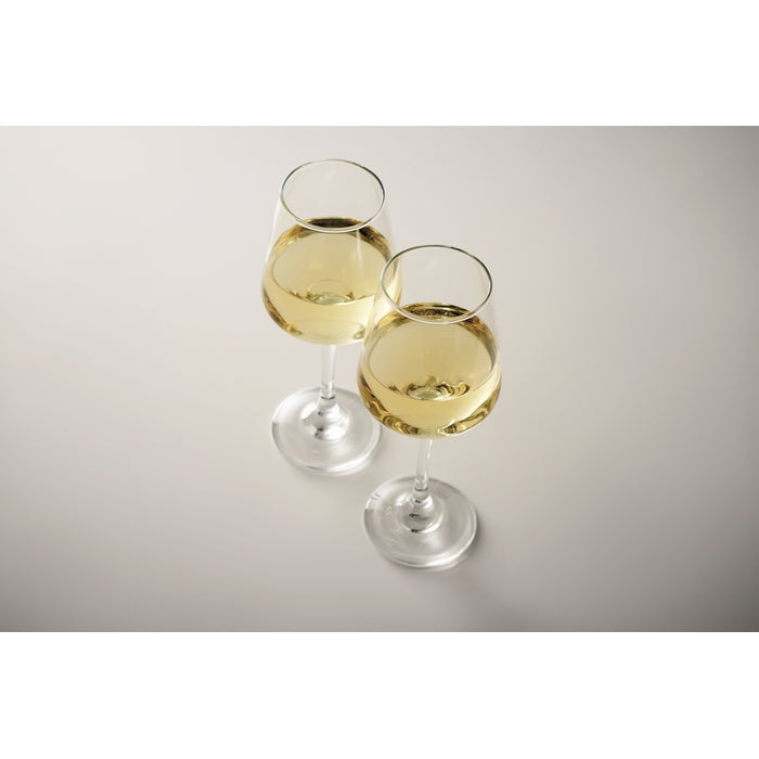 Two glasses of white wine on a gray background